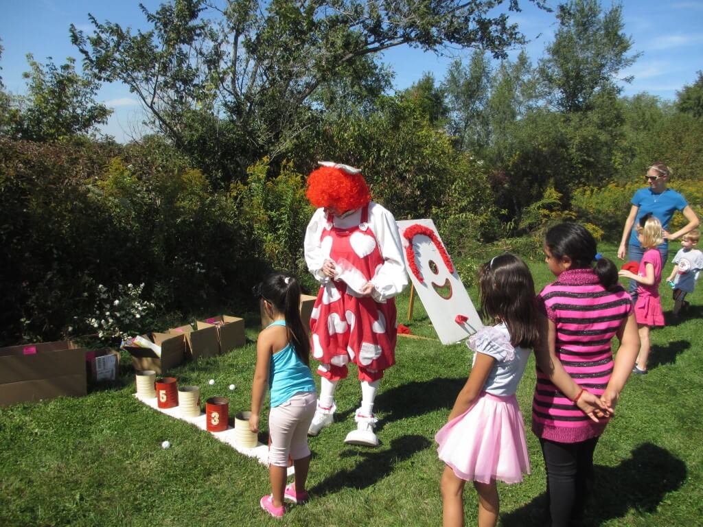 Clackers the Clown admiring Bozo's gift to childkind at the picnic.